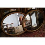 A pair of oval gilt framed wall mirrors, 20 1/2" x 16 1/4"