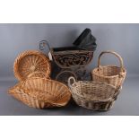 A doll's pram and three wicker baskets