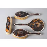 A silver pique and tortoiseshell dressing table set, comprising mirror, clothes brush and two hair