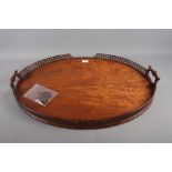 A late 19th century figured mahogany two-handled tray with pierced gallery, 29" wide (losses and