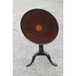 A Georgian mahogany circular fan paterae inlaid tilt top table, on birdcage and turned column tripod