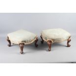 A pair of 19th century carved rosewood serpentine top stools, upholstered in a blue brocade, on