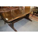 An Ercol dark oak refectory style dining table, 72" long x 34" wide x 28" high