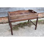 A butler's early 19th century mahogany tray, on later stand with moulded and stretchered supports,