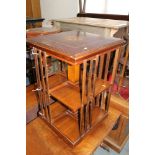An Edwardian walnut and inlaid square revolving bookcase, on quadruple castored support, 19"