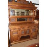 A late 19th century carved walnut mirror back sideboard, fitted single shelf over three drawers