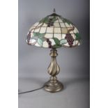 A Tiffany style lampshade with foliage and grape design and a twisted column lamp base, 24 1/3" high