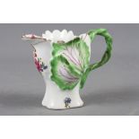 A Longton Hall cream jug with openwork twist handle and leaf relief decoration and enamel floral