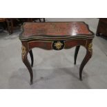 A 19th century Boulle work serpentine front fold-over top card table with gilt brass mounts, on