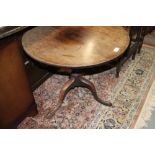 A 19th century mahogany circular tilt top low occasional table, on turned column and tripod splay
