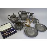 Two hammered pewter dishes, an 18th century pewter lidded jug, an EPBM three-piece teaset and