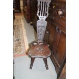 A carved oak spinning stool with fretwork back, on turned splay supports (for restoration) and an