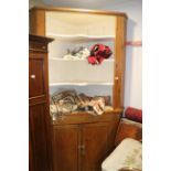 A pine corner cabinet with open shelves over two doors, on block base, 51" wide x 28" deep x 94"