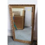 A rectangular wall mirror with scrolled gilt frame, 39" x 21"
