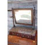 An early 19th century mahogany, ebony strung and painted swing frame toilet mirror, on plateau base,