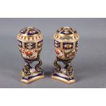 A pair of Davenport Imari decorated pot-pourri vases and covers (one repaired with losses), on