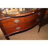 An Edwardian mahogany bowfront dressing chest, fitted oval mirror over two drawers, on square