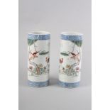 A pair of Chinese cylindrical vases, decorated birds and trees with blue dragon borders, 11" high