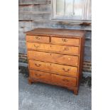 A late Georgian provincial fruitwood chest of two short and four long graduated drawers with bail