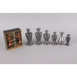 Five Japanese pewter saki bottles/decanters and a lacquered miniature chest of four drawers, 4" wide