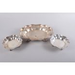 A shaped silver fruit dish, raised on four scroll feet, and two matching nut dishes, 42.5oz troy