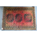 An Afghan gold washed Bokhara rug of traditional design with three guls, 54" x 38" approx