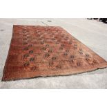 A Bokhara carpet of traditional design, forty-four guls on a deep ground and multi-bordered in
