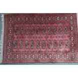 A Bokhara rug of traditional design with 20 guls on a pink ground, 47 1/2" x 31" approx