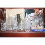 A quantity of glass vases, jugs and serving plates, including a vase with a flared rim, 14" high,
