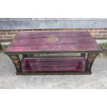 A lacquered and decorated low coffee table, on tapering supports united by an undertier, 44" wide