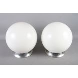 A pair of chrome spherical opaque glass light fittings