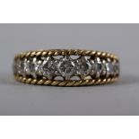 A yellow metal ring, set eleven graduated brilliant cut diamonds, size N, 6.4g