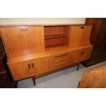 A G-Plan teak "Fresco" sideboard, fitted shelves and fall front cupboard over three drawers