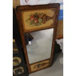 An early 20th century walnut and hand-painted overmantel mirror with flanking panels of vases of