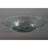 A clear glass oval bowl with waved edge, 20" wide