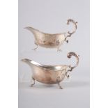 A pair of silver sauce boats with shaped borders and scrolled handles, 5oz troy approx