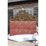 A carved giltwood and padded double bed head of Venetian design, 76" wide x 77" high