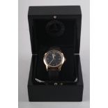 A gentleman's Mercedes Benz wristwatch with black dial and gilt baton and Roman numerals, brown