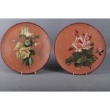 A pair of Watcombe terracotta plates, decorated roses, 12 1/2" dia (one chip to rim)