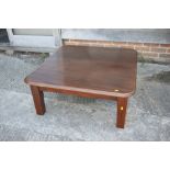 A mahogany low coffee table, on square taper supports, 38" wide x 36" deep x 15" high