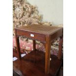 A mahogany cane seat dressing stool, on moulded supports, 18" wide x 13 1/2" deep x 16 1/2" high