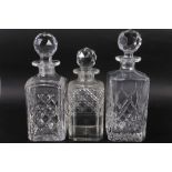 An early 20th century whisky decanter (small chips to stopper), two other whisky decanters (