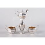A silver octagonal four-piece cruet set, 6.7oz troy approx, and a silver plated mustard spoon