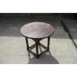 An oak circular top low occasional table, on turned and stretchered supports, 22" dia x 20" high