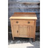 An early 20th century oak wash stand, fitted one long drawer over central cupboard, on turned