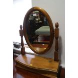 A pine oval swingframe toilet mirror, on shape top plateau base, 22" wide