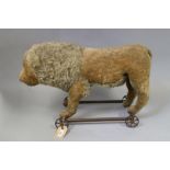 A child's Victorian ride-along straw stuffed lion, 25" long (losses)