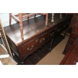 An 18th century oak dresser base, fitted three drawers over pot board, on turned supports, 68"