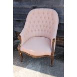 A walnut showframe tub shape armchair, button upholstered in a lattice fabric on cabriole supports