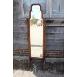 A 1930s walnut frame cheval mirror with shaped plate, 17" x 60" overall